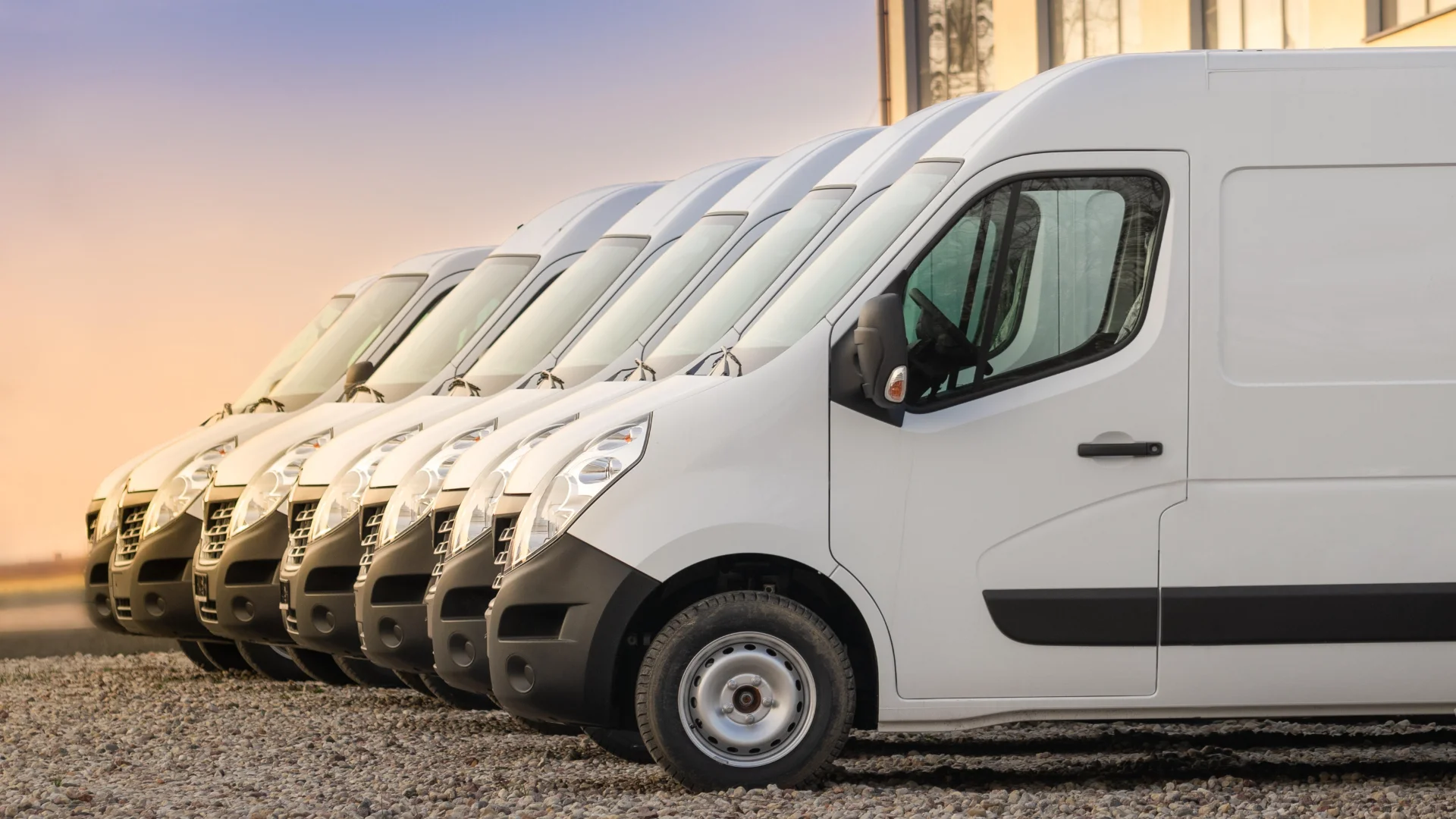 row of white delivery vans at sunrise 2026 03 16 04 35 06 utc